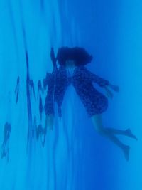 People swimming in blue sea