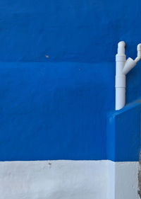 Close-up of blue pipe against wall