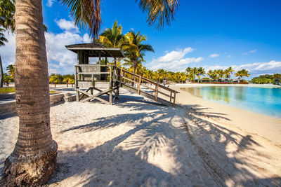 Built structure on beach against blue sky