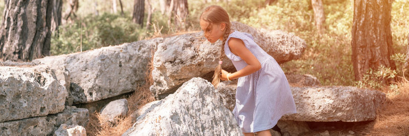 Kid girl traveler of eight years old travel and explore the ancient excavations of the ruins