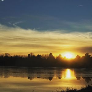 Scenic view of lake against sky during sunset