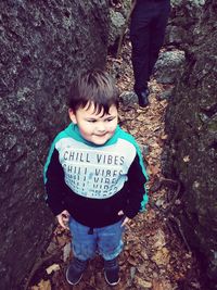 High angle view of boy standing in forest