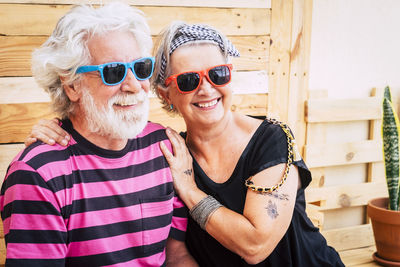 Smiling senior couple sitting outdoors