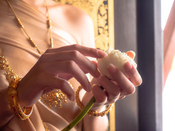 Midsection of woman holding hands
