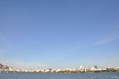 Buildings in city against blue sky