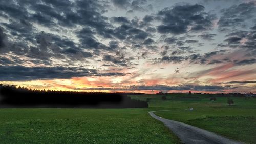 Scenic view of field against sky during sunset