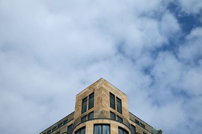 Low angle view of building against cloudy sky