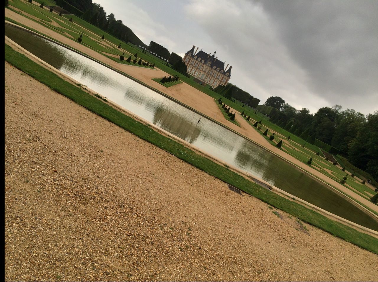 sky, architecture, cloud - sky, built structure, building exterior, cloudy, cloud, tree, travel destinations, history, water, outdoors, green color, day, nature, incidental people, travel, grass, famous place, no people