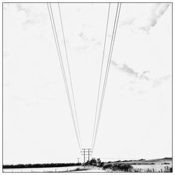 Low angle view of cables against sky