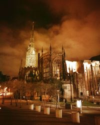 Illuminated temple against sky at night