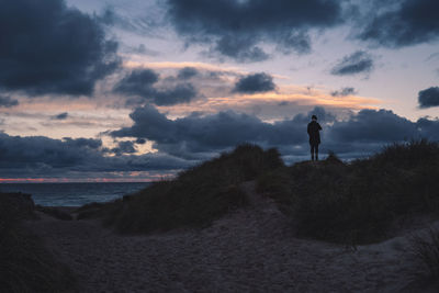 Rear view of man standing on beach