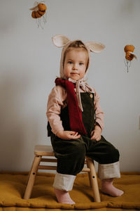 Toddler baby girl in funny hat with ears having fun