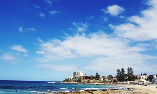 Panoramic view of sea and buildings against sky