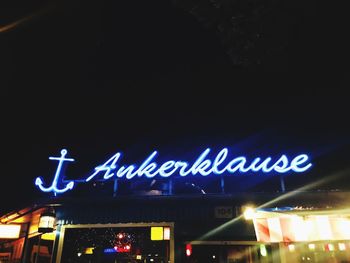 Low angle view of illuminated text at night