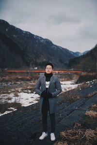 Full length portrait of man standing in snow