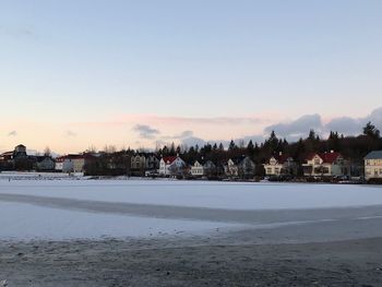 Scenic view of buildings against sky during winter