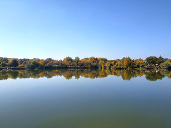 Scenic view of lake against clear blue sky