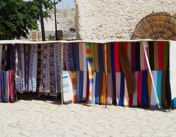 Multi colored umbrellas hanging on sand at beach