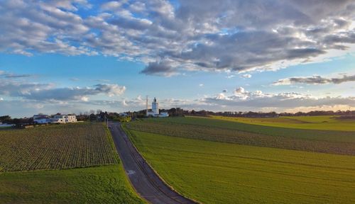 Scenic view of agricultural field against sky