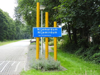 Road sign by trees