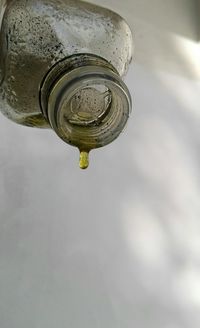 Close-up of water drop from faucet