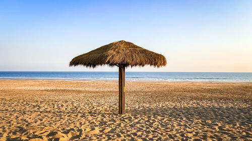 Lifeguard hut on beach against clear sky