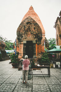Woman standing by wall