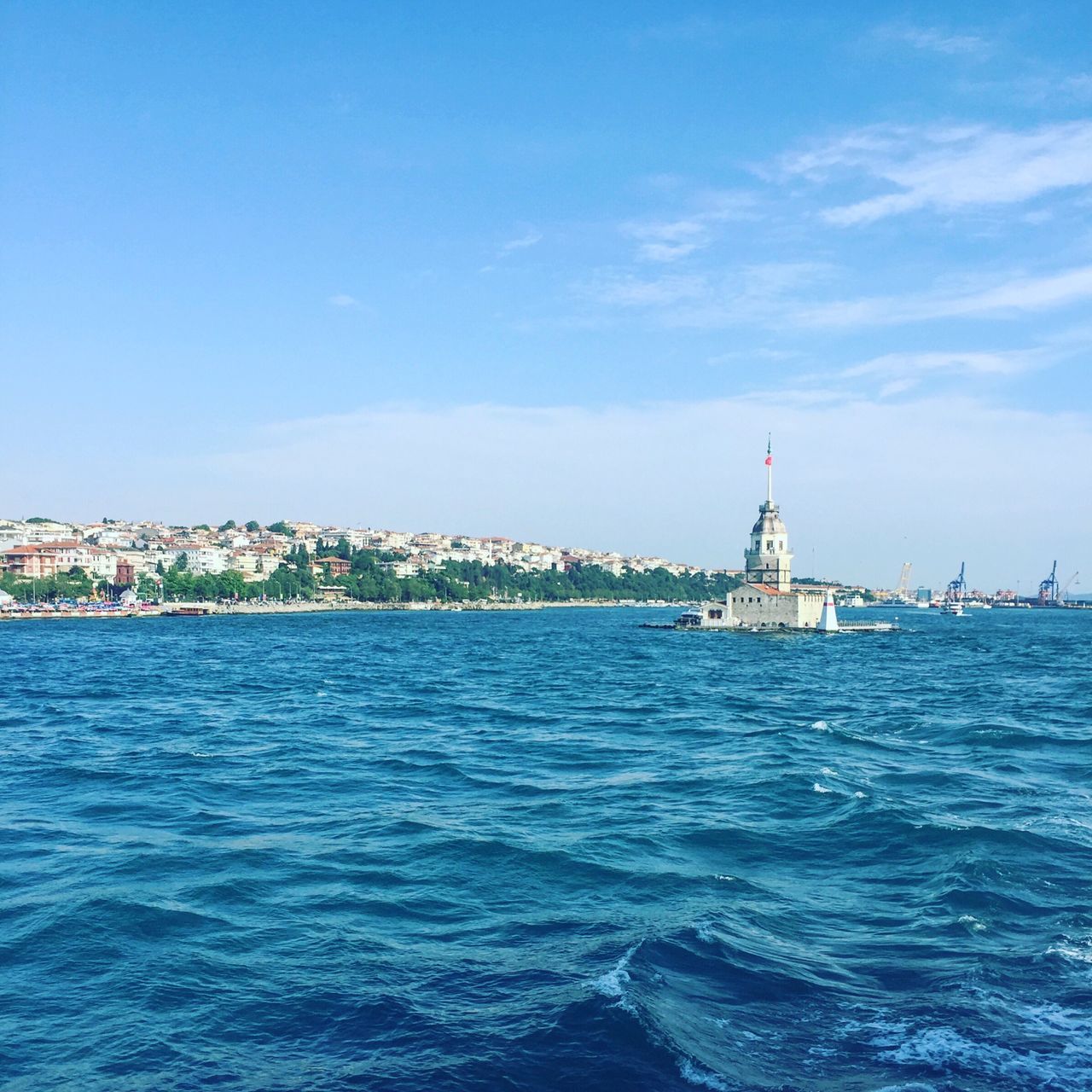 water, sea, blue, sky, waterfront, transportation, rippled, day, outdoors, no people, mode of transport, architecture, nautical vessel, travel destinations, beauty in nature, building exterior, nature, city, scenics, cityscape, sailing, sailboat