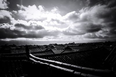 Cityscape against cloudy sky