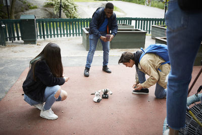 High angle view of friends having battle on robots