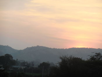 Scenic view of silhouette mountains against sky at sunset