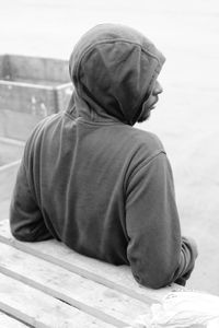 Man in hooded shirt standing in city