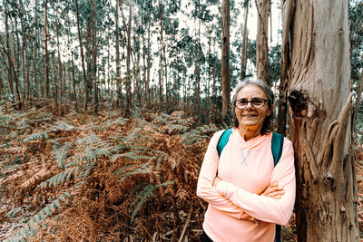 Portrait of a smiling young woman in forest