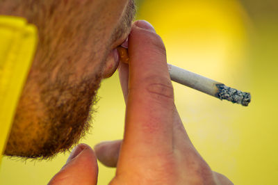 Cropped image of man smoking cigarette