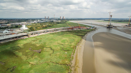 High angle view of river and cityscape against sky