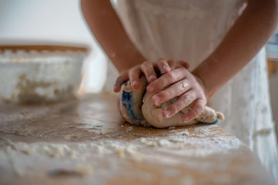 Close-up of woman preparing food on table