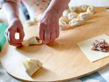 High angle view of person preparing food on cutting board