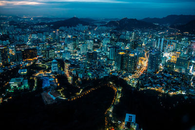 High angle view of city lit up at night