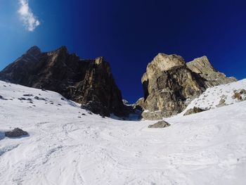 Scenic view of mountains against blue sky