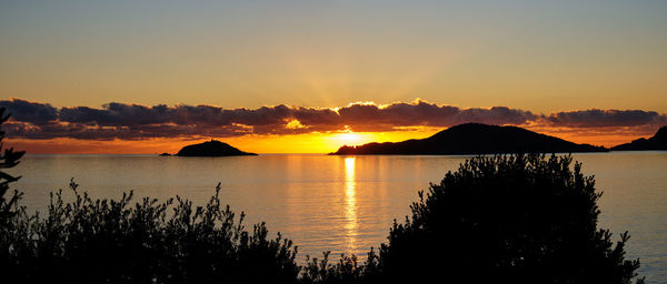 Scenic view of lake against sky during sunset