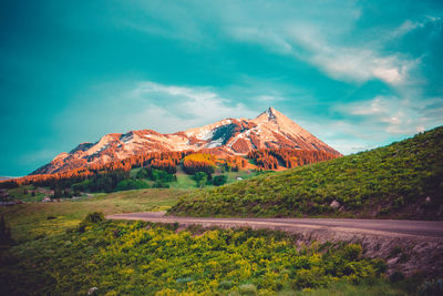 Scenic view of mountain against cloudy sky