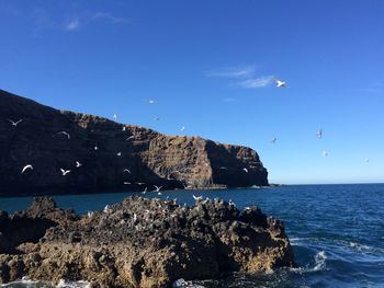 Scenic view of sea against clear blue sky