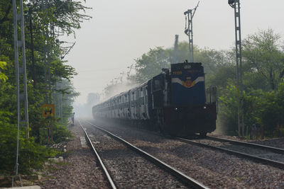 Train on railroad track against sky