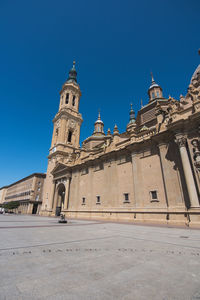 Low angle view of historical building against clear blue sky