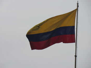 Low angle view of flag against clear sky