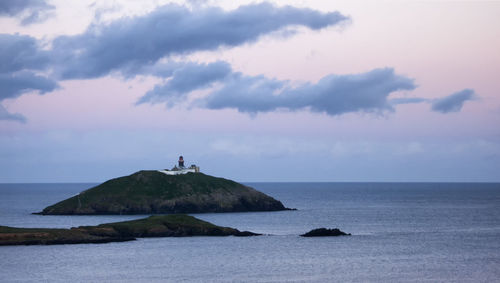 Ballycotton island and lighthouse in cork ireland including lighthouse surrounded by sea