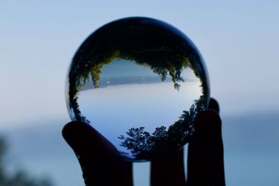 Reflection of person in sunglasses against sky