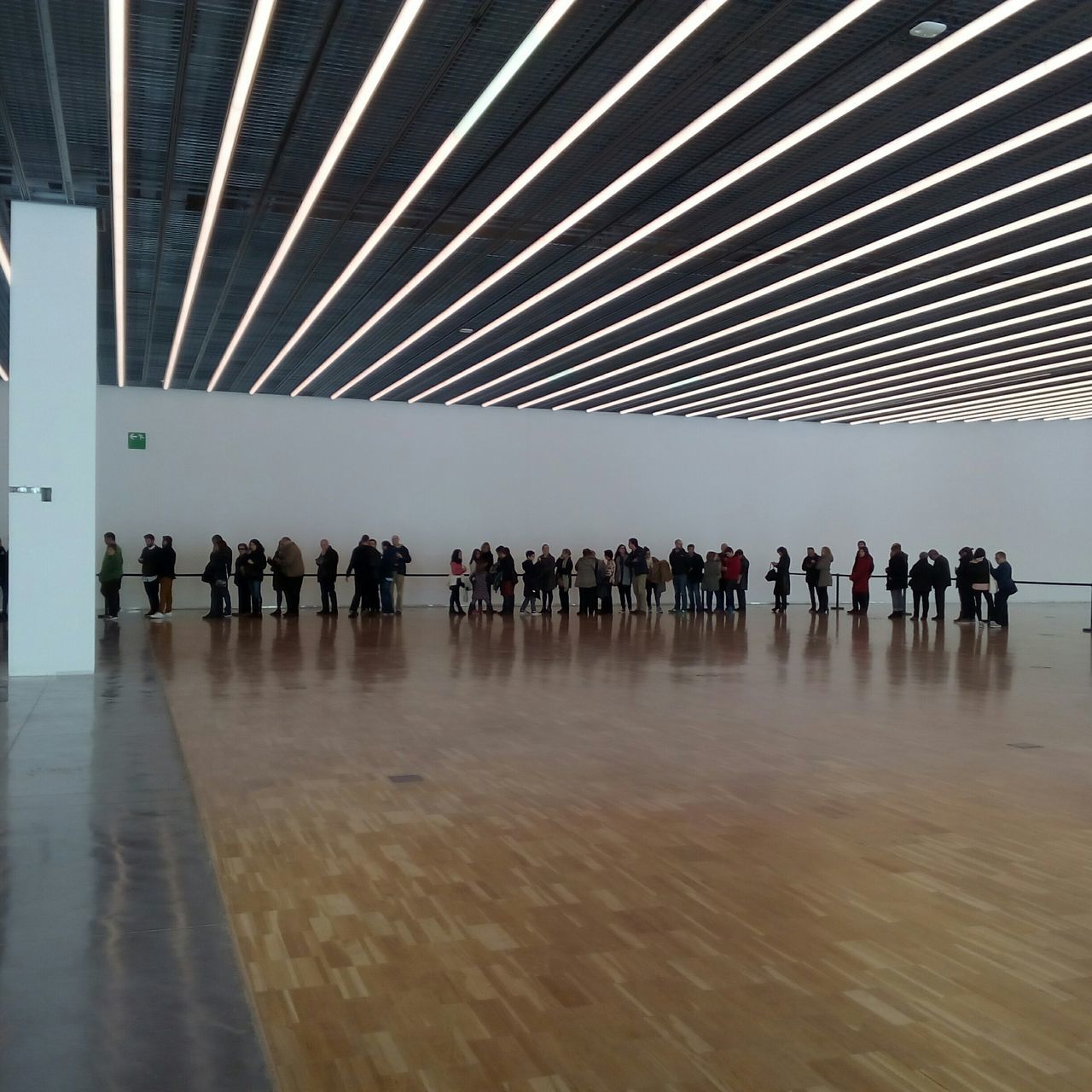 indoors, built structure, large group of people, architecture, walking, men, in a row, person, lifestyles, architectural column, reflection, the way forward, leisure activity, ceiling, group of people, modern, corridor, flooring, travel