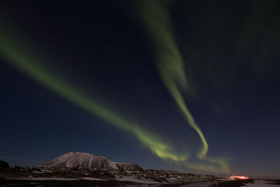 Scenic view of mountains against sky at night