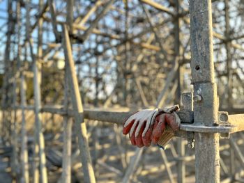 Carpenters pair of gloves hangging on scaffolding at sunset